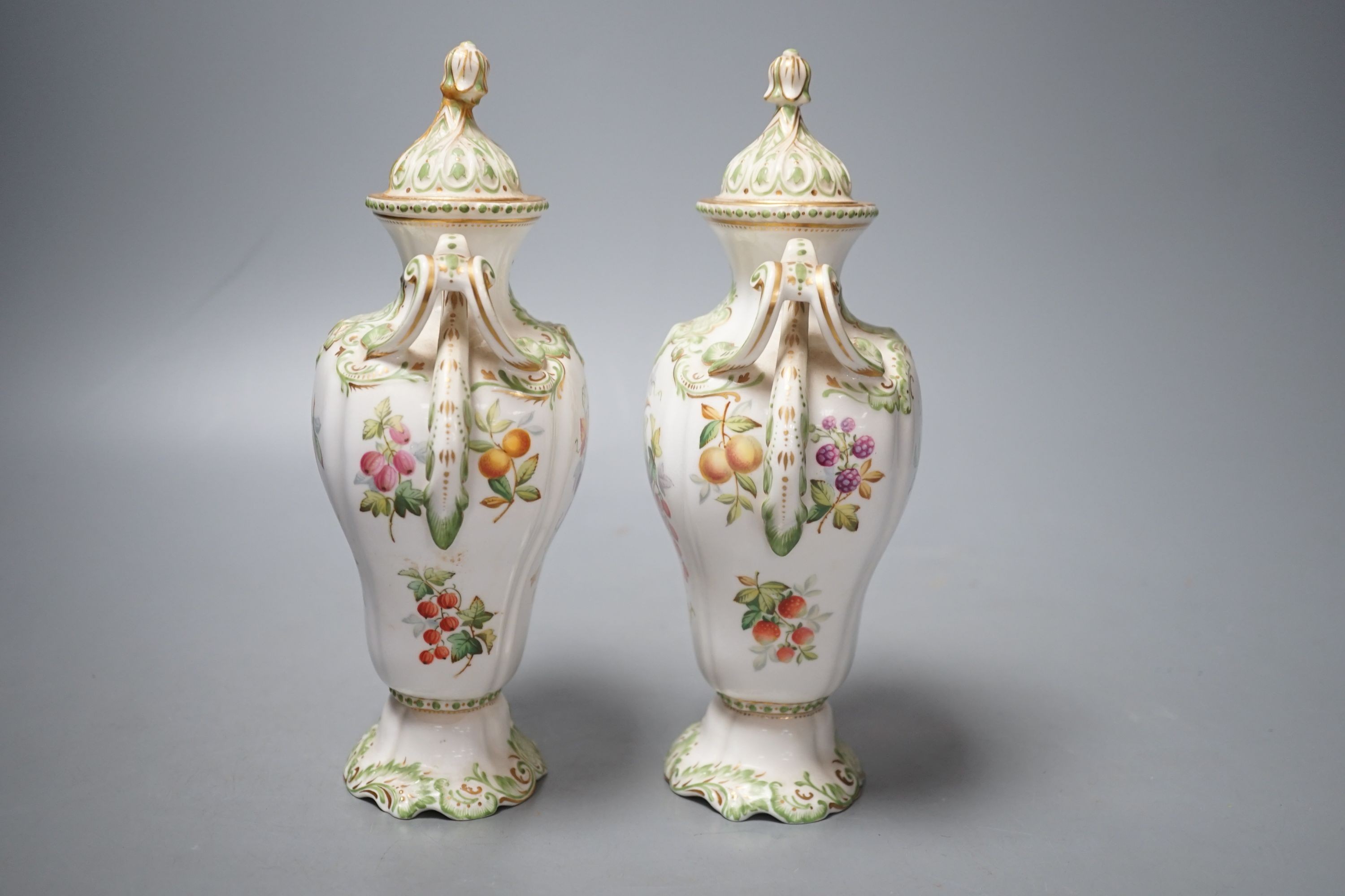 A pair of Copelands London, fruit decorated two handled vases and covers, circa 1900- 20cms high.